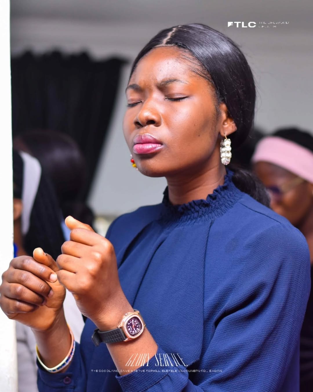 A member praying during a church gathering